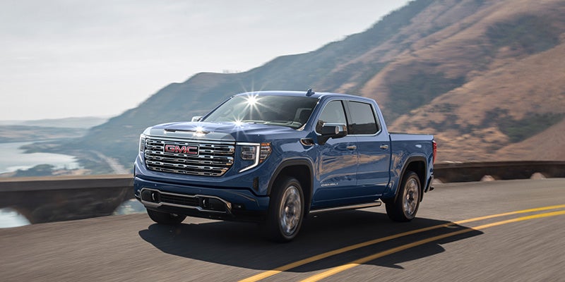 2025 GMC Sierra 1500 in Blue - Driving Down Highway